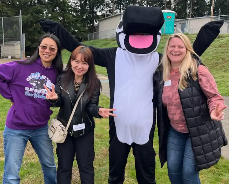 volunteers with whale mascot